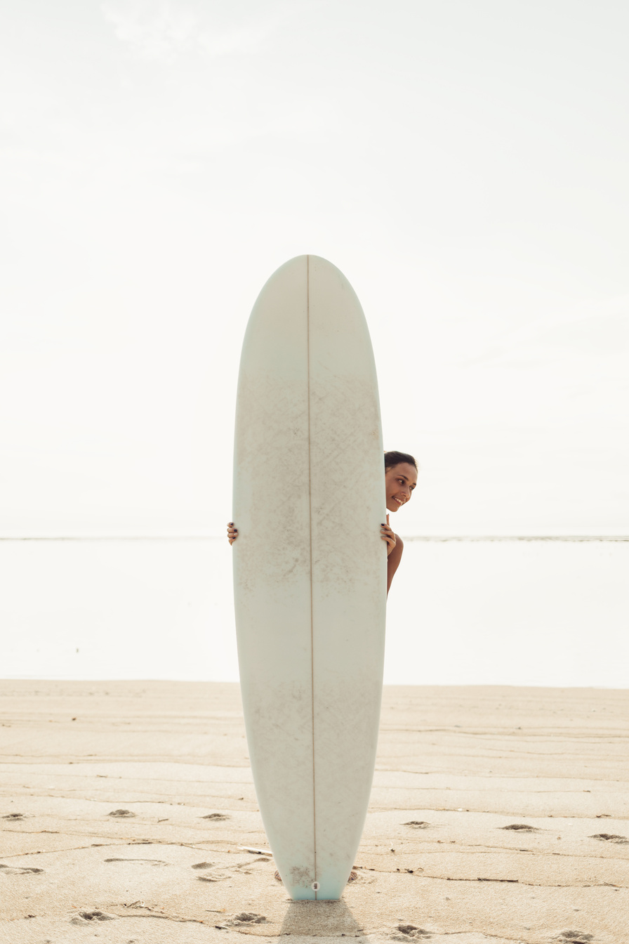 Woman behind Surfboard